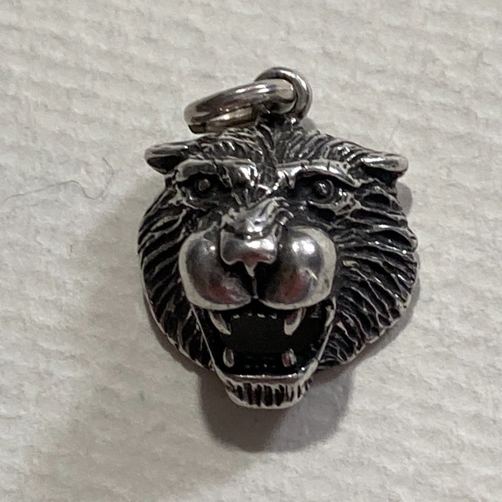Ferocious little silver lion's head pendant or charm